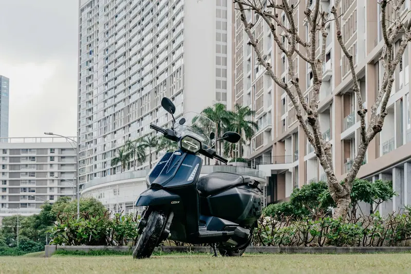 Lambretta X300 GT màu xanh navy với kính chắn gió, đậu trước toà chung cư